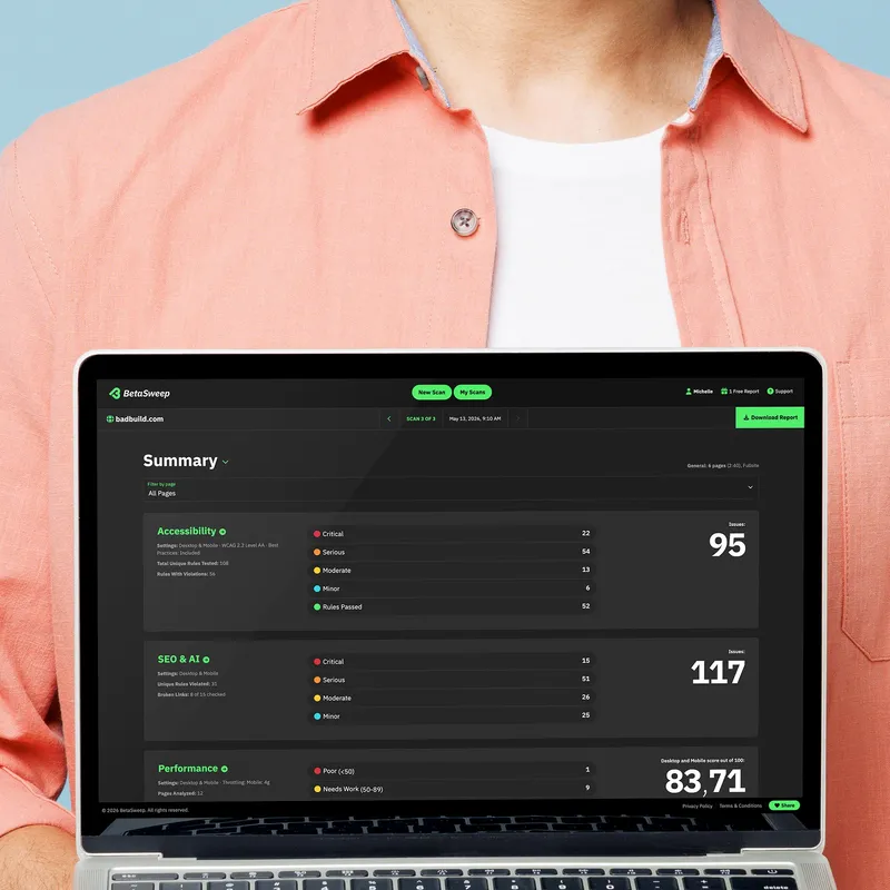 A young man in a button down shirt holding a laptop showing a summary of a BetaSweep scan
